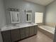 Dual sink bathroom featuring custom cabinetry and granite countertops at 1608 Fox Glen Ct, Winter Springs, FL 32708