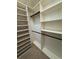 Walk-in closet with custom shelving and rods for storage at 1608 Fox Glen Ct, Winter Springs, FL 32708