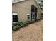 Home exterior showing a screened lanai, lush landscaping, and a peaceful backyard environment at 1608 Fox Glen Ct, Winter Springs, FL 32708