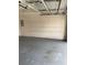 Two-car garage with overhead door, ample storage space, and utility access at 1608 Fox Glen Ct, Winter Springs, FL 32708