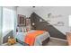 Modern bedroom featuring a graphic wall with decorative shelves at 4842 Waltham Forest Dr, Davenport, FL 33837