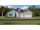 Charming single-Gathering home featuring a three car garage and manicured lawn at 4842 Waltham Forest Dr, Davenport, FL 33837