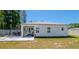View of the back of the home with a covered patio and fenced in yard at 8007 Sw 135Th Loop, Ocala, FL 34473