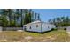 The home is surrounded by a white fence and mature trees at 8007 Sw 135Th Loop, Ocala, FL 34473