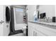 Cozy bathroom featuring a shower/tub combo, grey tile, and a vanity with granite countertop at 8007 Sw 135Th Loop, Ocala, FL 34473