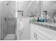 Stylish bathroom showcasing granite countertop, white cabinets, and a tiled shower with built-in niche at 8007 Sw 135Th Loop, Ocala, FL 34473