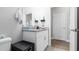 Compact bathroom showing a vanity with granite counter, and a toilet near the door at 8007 Sw 135Th Loop, Ocala, FL 34473