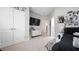 Bedroom featuring plush carpet, closet, and natural light, creating a welcoming and serene atmosphere at 8007 Sw 135Th Loop, Ocala, FL 34473