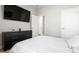 Inviting bedroom featuring a large television, dresser, and a comfortable white bedspread at 8007 Sw 135Th Loop, Ocala, FL 34473
