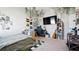 Bright bedroom with a large TV, bed, desk and carpet flooring, providing an inviting living space at 8007 Sw 135Th Loop, Ocala, FL 34473