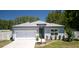 Charming single-story home featuring a two-car garage, fresh landscaping, and a cozy, welcoming entrance at 8007 Sw 135Th Loop, Ocala, FL 34473