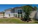 Well-maintained front yard with lush grass, decorative shrubs, and a concrete walkway leading to the house at 8007 Sw 135Th Loop, Ocala, FL 34473