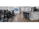 Open concept kitchen with granite countertops, stainless steel appliances, and breakfast bar at 8007 Sw 135Th Loop, Ocala, FL 34473