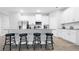 Modern kitchen featuring white cabinets, granite countertops, stainless steel appliances, and breakfast bar seating at 8007 Sw 135Th Loop, Ocala, FL 34473