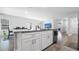 Stylish kitchen island with granite countertops and white cabinets, seamlessly connecting to the dining area at 8007 Sw 135Th Loop, Ocala, FL 34473