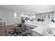 Open-concept living area with a modern kitchen, comfortable white sofa, and stylish black and white rug at 8007 Sw 135Th Loop, Ocala, FL 34473