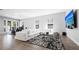 Stylish living room with a comfortable white sectional sofa and access to the backyard patio at 8007 Sw 135Th Loop, Ocala, FL 34473