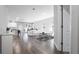 Bright open-concept living space with hardwood floors and neutral color palette, seamlessly connecting to the kitchen at 8007 Sw 135Th Loop, Ocala, FL 34473