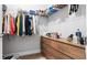 Spacious walk-in closet with built-in wooden drawers, shelving, and hanging rods for optimal storage at 8007 Sw 135Th Loop, Ocala, FL 34473