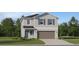 Charming two-story home with a two-car garage, landscaped yard, and neutral color palette at 970 Hour Glass Rd, Lakeland, FL 33801