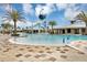 Resort-style community pool with splash zone, clubhouse, palm trees, and lounge chairs at 1833 Fulfillment Dr, Kissimmee, FL 34744