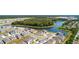 A serene aerial view of a vibrant neighborhood nestled alongside a lush green forest and tranquil lake at 2115 Forage Dr, Kissimmee, FL 34746