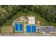 Aerial view of community sports complex featuring tennis courts, basketball courts, a beach volleyball court and playground at 2115 Forage Dr, Kissimmee, FL 34746
