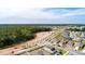 Aerial view shows a neighborhood surrounded by construction and greenery at 2115 Forage Dr, Kissimmee, FL 34746