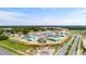 An aerial view showcases the construction progress of a community with framed houses and well-planned street at 2115 Forage Dr, Kissimmee, FL 34746