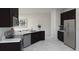 Modern kitchen with sleek countertops, stainless steel appliances, and dark cabinets at 2115 Forage Dr, Kissimmee, FL 34746