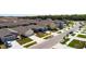 New homes line a street with manicured lawns and landscaping at 2115 Forage Dr, Kissimmee, FL 34746