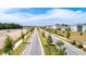 Long street view featuring brand new homes and landscaping under construction on a sunny day at 2115 Forage Dr, Kissimmee, FL 34746