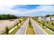 Long street view featuring brand new homes and landscaping under construction on a sunny day at 2115 Forage Dr, Kissimmee, FL 34746