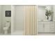 Bathroom featuring a shower with tile surround, neutral shower curtain, and a white vanity at 2157 Albatross Nest Dr, Bartow, FL 33830