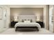 Cozy primary bedroom showcasing a plush bed, neutral color scheme, bedside tables, and elegant lamps at 2157 Albatross Nest Dr, Bartow, FL 33830