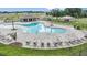 Community pool with lounge chairs, tables, clubhouse, and playground at 2200 Albatross Nest Dr, Bartow, FL 33830