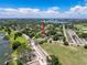 An aerial neighborhood view reveals its peaceful residential setting near a picturesque lake and a vibrant green recreational park space at 800 W Lake Elbert Ne Dr, Winter Haven, FL 33881