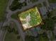 Aerial view of a home with mature trees and manicured landscaping at 800 W Lake Elbert Ne Dr, Winter Haven, FL 33881