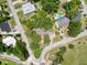 An aerial view of the neighborhood, with mature trees and manicured lawns, highlights the home's attractive landscaping at 800 W Lake Elbert Ne Dr, Winter Haven, FL 33881