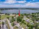 Overhead view of homes in a quiet neighborhood with a large lake nearby at 800 W Lake Elbert Ne Dr, Winter Haven, FL 33881