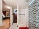Well-lit bathroom showcases a tiled shower and patterned floor with a glimpse into the adjoining room at 800 W Lake Elbert Ne Dr, Winter Haven, FL 33881