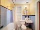 Vintage bathroom with blue tiling, classic fixtures, and built-in shelving, blending retro charm with functionality at 800 W Lake Elbert Ne Dr, Winter Haven, FL 33881