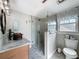 Modern bathroom boasts a glass shower, copper sink, and stylish finishes for a luxurious experience at 800 W Lake Elbert Ne Dr, Winter Haven, FL 33881