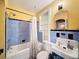 Charming vintage bathroom featuring blue tile, a classic sink, and built-in shelves for a retro touch at 800 W Lake Elbert Ne Dr, Winter Haven, FL 33881
