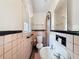 Classic bathroom with pink tile, vintage sink, and patterned floor tiles at 800 W Lake Elbert Ne Dr, Winter Haven, FL 33881