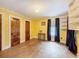 Sunny bedroom with hardwood floors, bright yellow walls, and built-in shelving, offering a cheerful atmosphere at 800 W Lake Elbert Ne Dr, Winter Haven, FL 33881