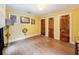 This bedroom features hardwood floors, three doors, and bright yellow walls, creating a cozy space at 800 W Lake Elbert Ne Dr, Winter Haven, FL 33881