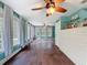 Bright bedroom with natural light, features hardwood floors, a ceiling fan, and a classic dresser at 800 W Lake Elbert Ne Dr, Winter Haven, FL 33881
