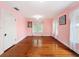 Spacious bedroom with hardwood floors, pink walls, and natural light at 800 W Lake Elbert Ne Dr, Winter Haven, FL 33881