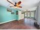 Spacious bedroom with lots of natural light, complemented by hardwood floors and ceiling fans at 800 W Lake Elbert Ne Dr, Winter Haven, FL 33881
